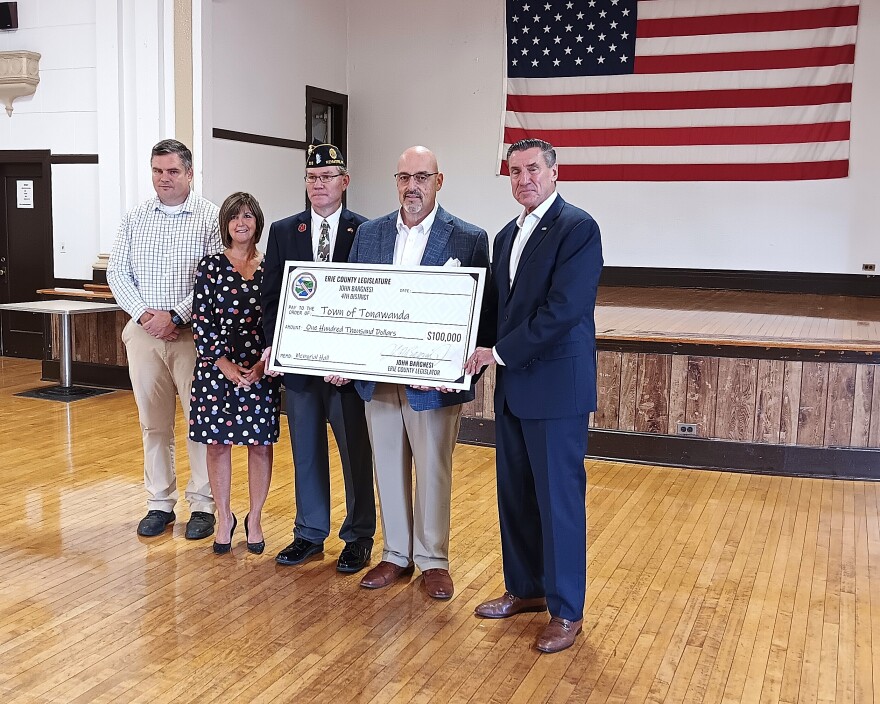 From left to right, Town of Tonawanda engineer Matt Sutton, Deputy Town Supervisor Gina Santa Maria, Brounshidle Post Commander Nick Scott, Erie County Legislator John Bargnesi, and Town Supervisor John Flynn stand with a ceremonial check from Erie County for funding to cover repairs at the Milton Brounshidle Post.