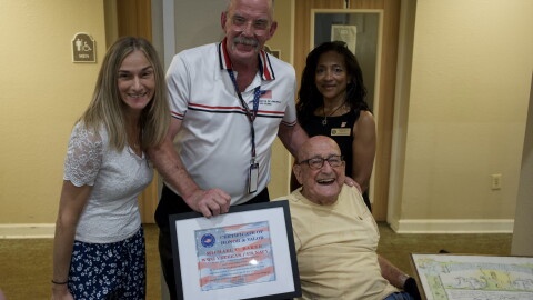 Michael Baker, bottom right, is presented with a Certificate of Honor & Valor pictured with Pratima Strong, top right, Todd Belknap, center, and Shelly Weinhart, top left.