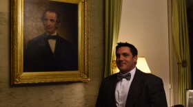 Historian Corey Curtis stands next to a portrait of Moses Pettengill.