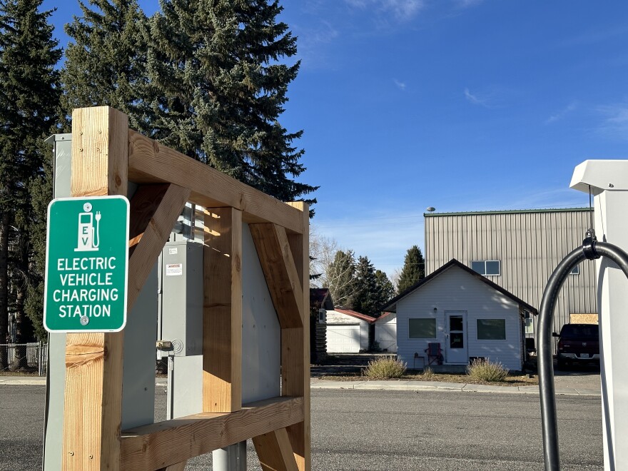 A green sign that says, "Electric Vehicle Charging Station."