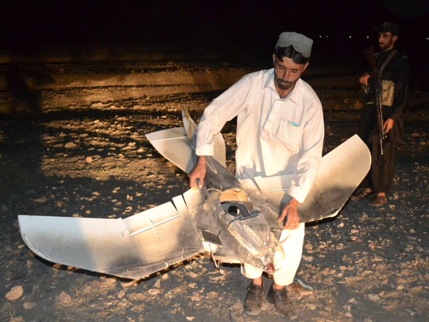 A Pakistani villager holds the wreckage of a suspected surveillance drone that crashed in the Pakistani town of Chaman along the Afghanistan border on Aug. 25. The number of drone strikes has increased fivefold during the Obama administration.