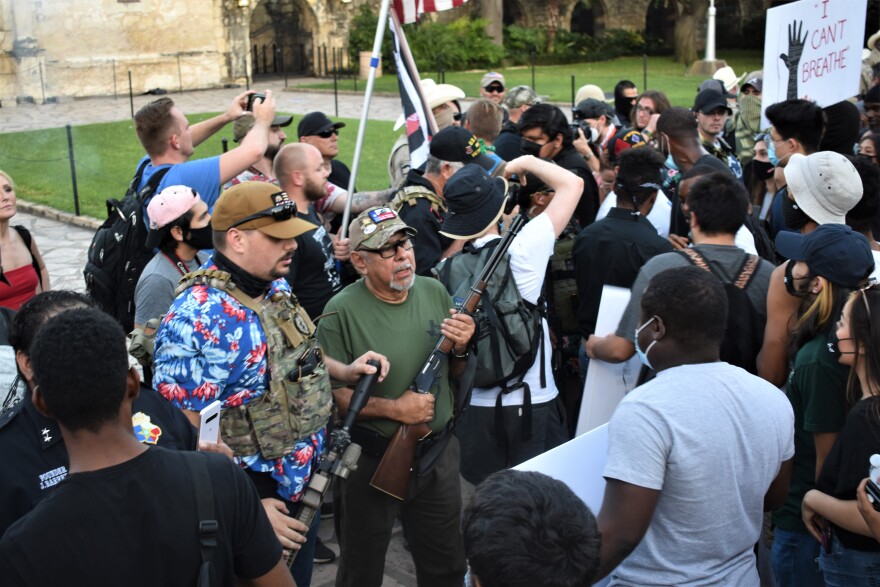 This Is Texas Freedom Force members and supporters stand in front of Black Lives Matters protestors on May 30 in front of the Alamo. 