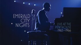 An album cover featuring a man sitting at piano. 