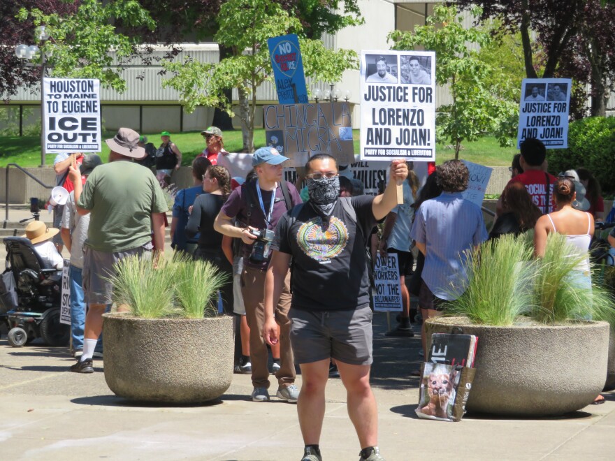 People protesting outside building. 