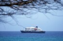 A cruise ship is anchored at a port 