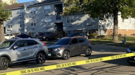 Yellow police tape outside an apartment building