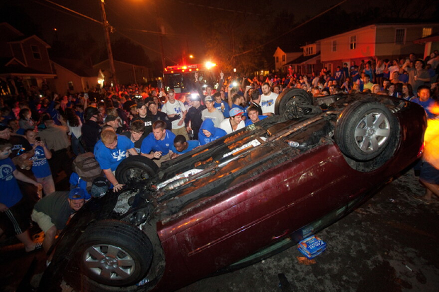 Kentucky fans helped turn a car back onto its wheels on State Street after it had been flipped over by others during Saturday night's celebration. Police said there were several arrests.