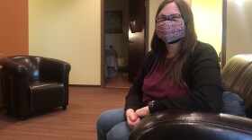 Elizabeth Dick, 53, waits in the waiting area of a local clinic after getting the first dose of the COVID-19 vaccine. "I have been confined to my house for almost a year now of just being extremely careful and to teach high school and haven't even really wanted to teach in the building because people had different understandings early on of what was proper and non proper mask wearing. So it's been very, very cautious. So I'm excited," Dick said. (Mayowa Aina/Alaska Public Media)