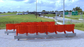 The park has stadium seats where people can sit and watch cars go by.