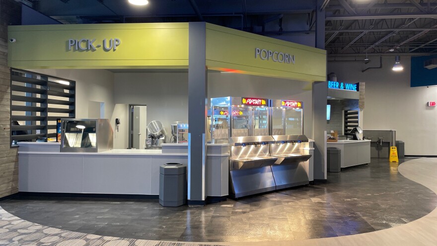  Moviegoers in Alton call fill their own orders for popcorn and drinks instead of waiting for something from behind the counter.