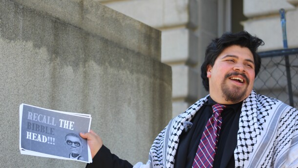 Juan Diaz, the Clevelander who filed a petition to recall Mayor Justin Bibb, holds up a sign that reads, "Recall the Bibble-head!!!"