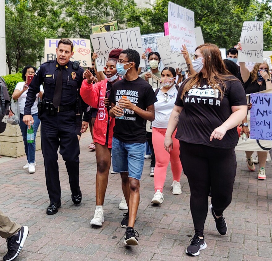 CMPD Capt. Brad Koch talks with marchers in a protest Sunday, May 31, in uptown Charlotte. 