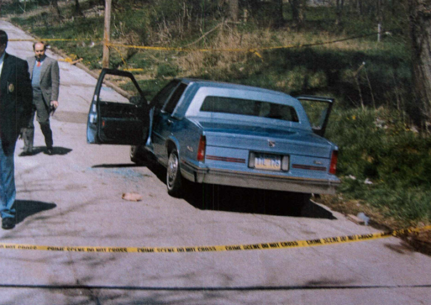 The 1994 crime scene photo of the blue Cadillac DeVille on Hutchings Street in Kansas City, Kansas, where Donald Ewing and Doniel Quinn were killed by a man dressed in black with a shotgun.