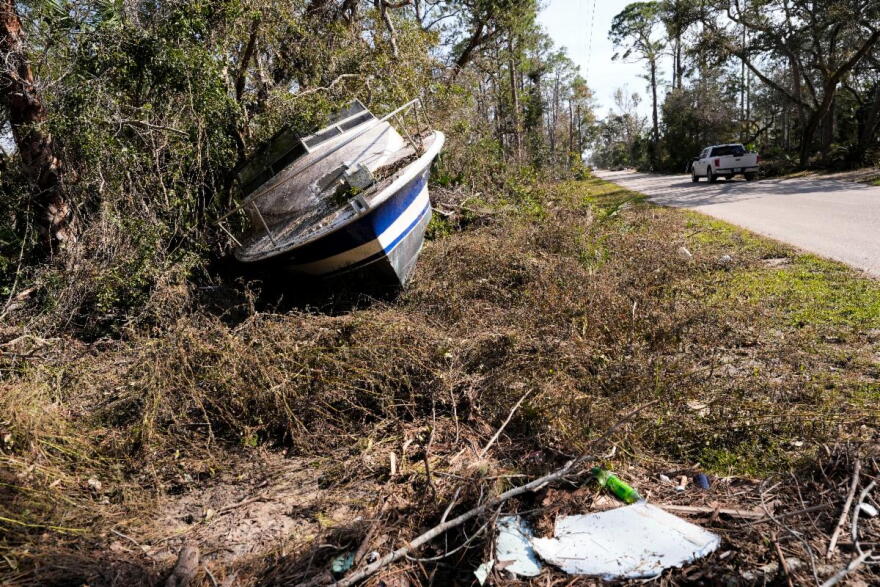 A boat that was washed onto a residential street from the storm surge stands in the aftermath of Hurricane Helene, in Steinhatchee, Fla., Saturday, Sept. 28, 2024.