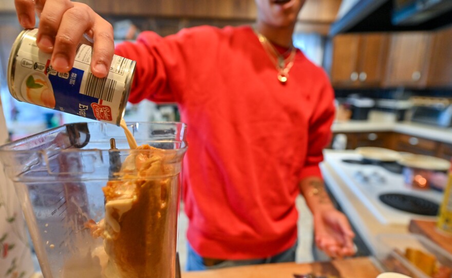 Aidan McFarlane adds one can of evaporated milk to the blender.