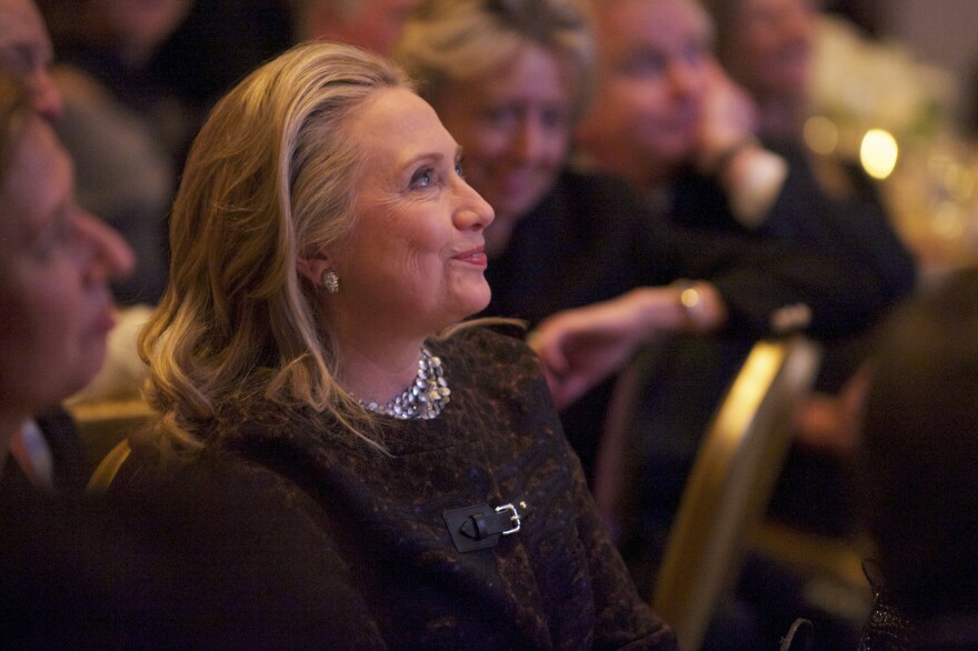 Secretary of State Hillary Clinton watches a video about her public life that was played before she addressed the Saban Forum in Washington last week.