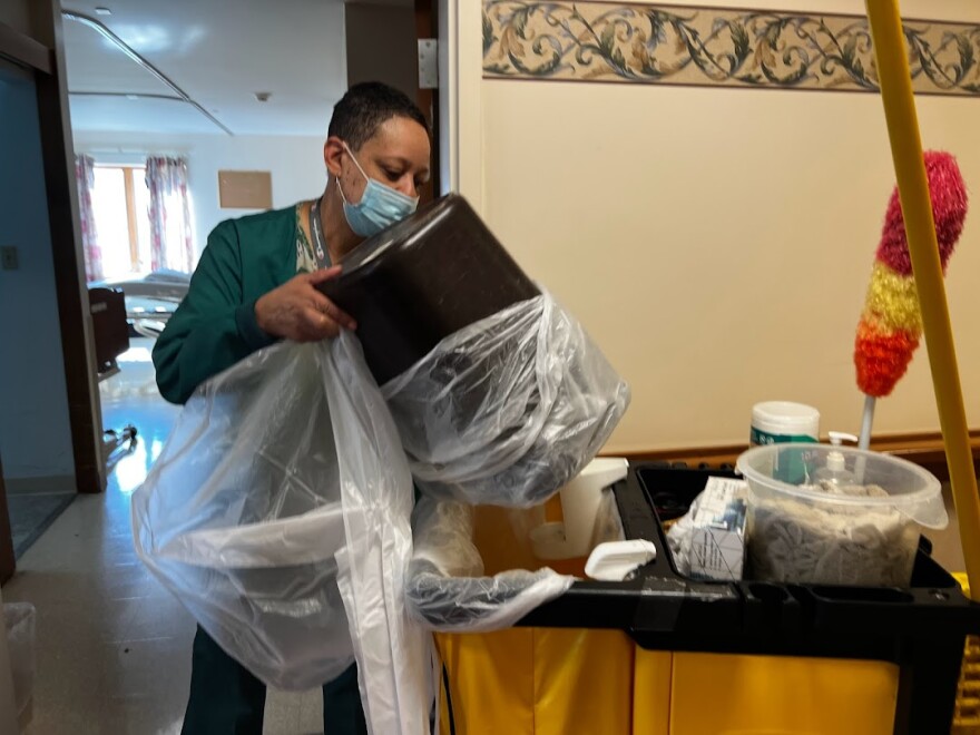 Briggett Martin cleans rooms at the Eliza Bryant Village nursing home.