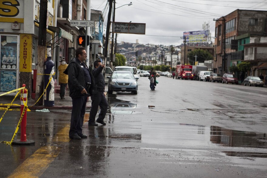 Tijuana police redirect traffic at an intersection due to flooding, December 13, 2012.