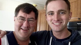 In this undated photo provided by David Taylor Sr., he poses with his son David Taylor, right, a former Marine. Taylor Sr. told The Associated Press on Tuesday that he was notified by the U.S. State Department that his son was killed earlier this month in Syria while fighting for a Kurdish militia battling the Islamic State group. (Courtesy of David Taylor Sr. via AP)