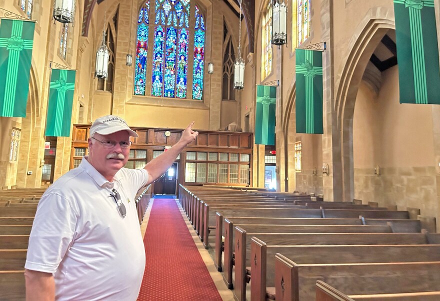 Dave Howland, vice president of the church council at First Lutheran Church in Galesburg, points to bell from the church sanctuary.