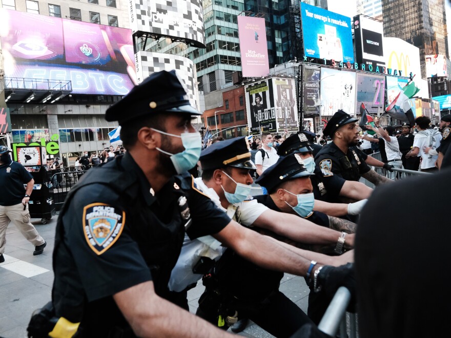 Pro-Palestinian protesters face off with a group of Israel supporters and police in a clash that turned violent in Times Square last week in New York City.