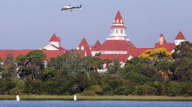 An Orange County Sheriffs helicopter searches for a young boy early Wednesday, June 15, 2016, after the boy was dragged into the water Tuesday night by an alligator near Disney's upscale Grand Floridian Resort & Spa in Lake Buena Vista, Fla. (Red Huber/Orlando Sentinel via AP)