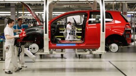 Workers assemble Volkswagen Golf 6 cars at the Volkswagen factory in Wolfsburg, Germany. Volkswagen and other German automakers are among those driving Germany's economic boom.