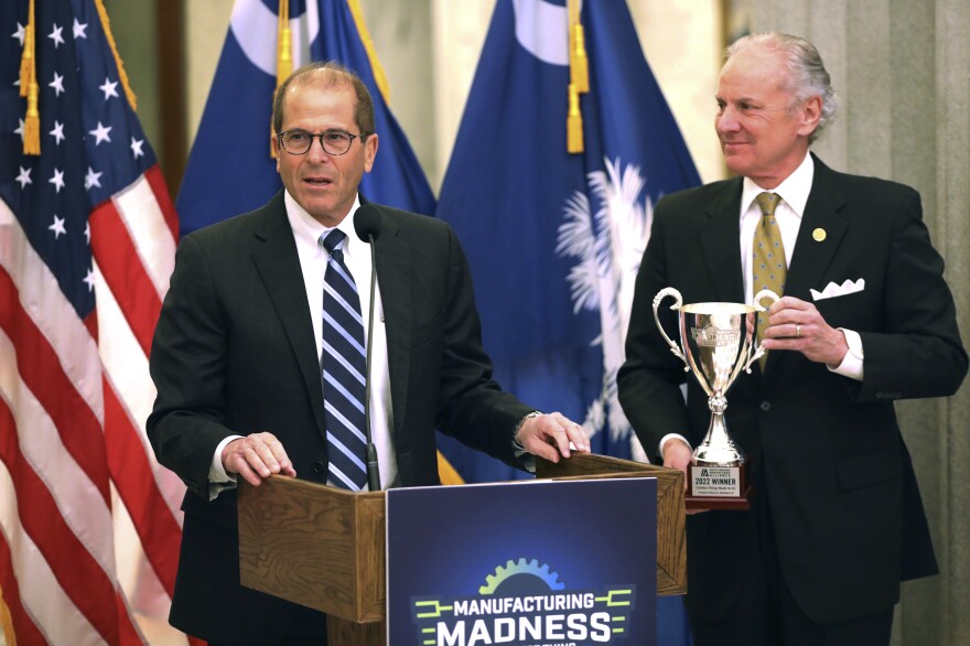 Nucor Vice President Mike Lee speaks as South Carolina Gov. Henry McMaster holds a trophy after Nucor's steel was named the coolest thing made in South Carolina.