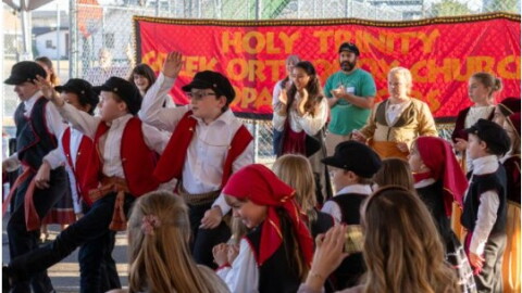 Children dressed in traditional Greek clothing dance at the annual Greek Festival.