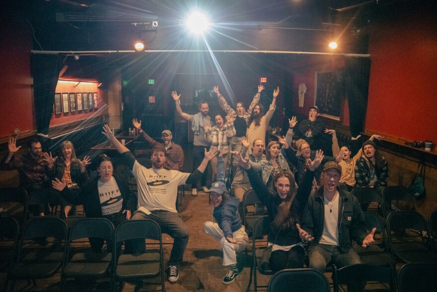 attendees at a film screening pose for a photo.