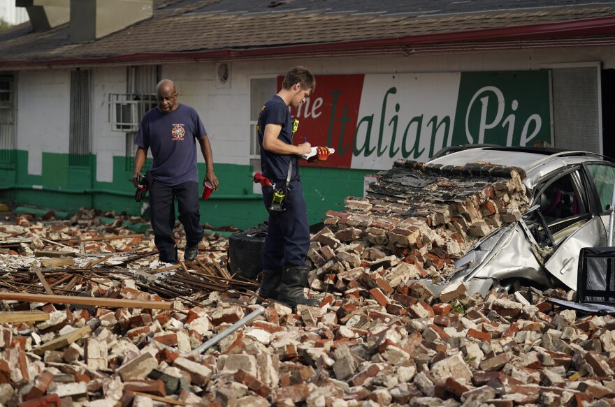 New Orleans Firefighters assess damages as they look through debris after a building collapsed from the effects of Hurricane Ida on Monday in New Orleans, La. 