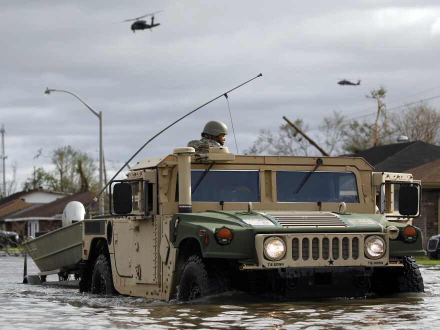 A National Guard vehicle drives through floodwater left behind by Hurricane Ida in LaPlace, Louisiana, U.S., on Monday, Aug. 30, 2021. The storm, wielding some of the most powerful winds ever to hit the state, drove a wall of water inland when it thundered ashore Sunday as a Category 4 hurricane and reversed the course of part of the Mississippi River.