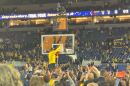 Head Coach Dusty May cuts down the net after Michigan wins.