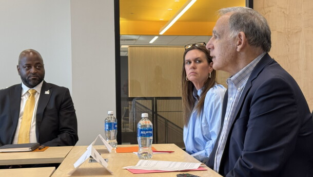 Sen. John Boozman (right) and Gov. Sarah Huckabee Sanders (middle) speak with catfish farmers and aquaculture experts at the University of Arkansas at Pine Bluff, as the school's Chancellor Anthony Graham (left) listens.