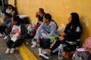 Relatives wait outside Zone 7 of the Bolivarian National Police, where political detainees are held, after spending the night there in Caracas, Venezuela, Monday, Jan. 12, 2026.