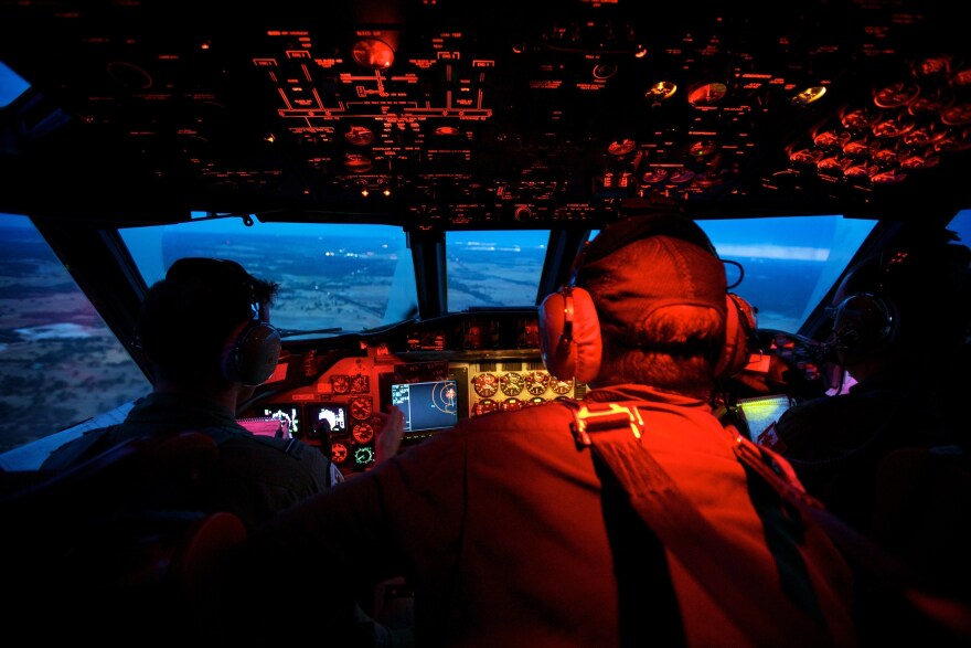Crew members onboard a RAAF AP-3C Orion cross the coast of Perth, Australia, having just completed an 11-hour search mission for Malaysia Airlines Flight 370.