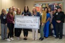 The St. Joseph Memorial Hospital Mission and Values Team displays the money it raised for the local food pantry.