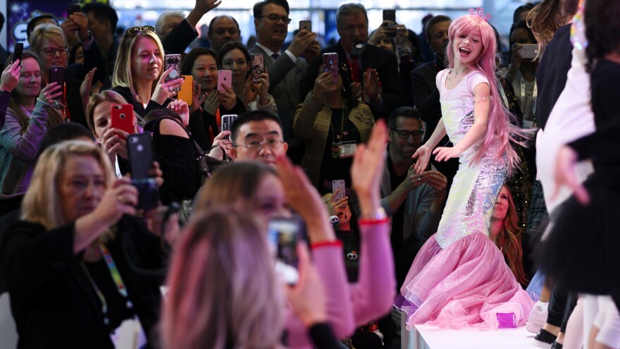 A girl dressed as a mermaid worked the runway at a fashion show at the toy show.