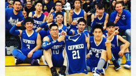 The Kipnuk Falcon boys basketball team with Quintin "Muggie" Peter's number 21 jersey.