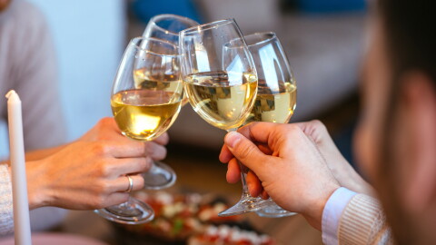 Friends clinking with glasses of wine