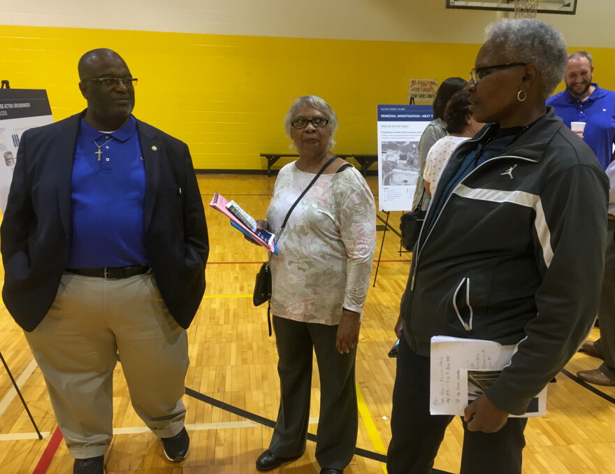 A TVA employee (left) answers questions at a public forum at the Mitchell Community Center, October 8, 2019. 