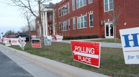 A red sign which reads "Polling Place" staked in the lawn in front of the Pender County Hampstead Annex. 