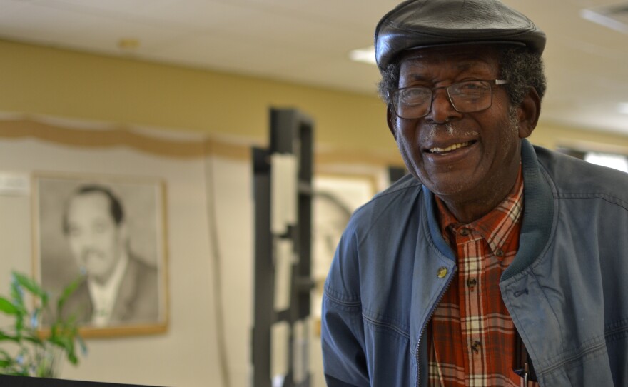 Mitch Williams, 85, grew up in Mound Bayou and became a patient after Delta Health Center opened. He later got a job at the health center and now serves on the clinic's Board of Directors. He was photographed in an exhibit of the clinic's history, near a portrait of Andrew James, who was the center's director of environmental improvement.