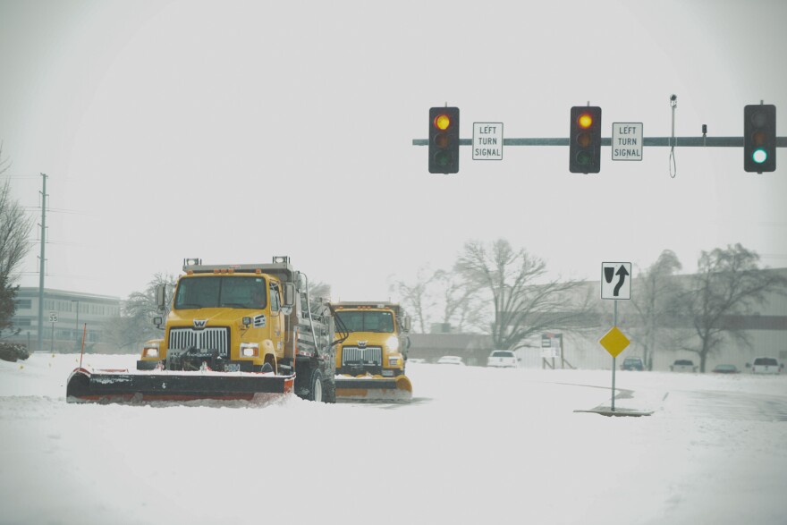 Missouri Department of Transportation snow plows make the turn from Independence Avenue and Strother Road toward I-470 in Lee's Summit on Jan. 5, 2025.