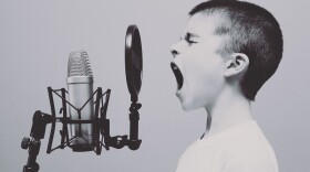 Boy screaming in microphone