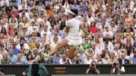 Tunisia's Ons Jabeur kicks the ball after failing to chase down a volley by Aryna Sabalenka of Belarus in their women's singles semifinal match on day eleven of the Wimbledon tennis championships in London, Thursday, July 13, 2023. (AP Photo/Alberto Pezzali)