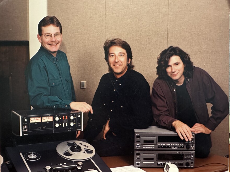 A vintage photo of Mark Simmet, Bob Dorr and Al Schares posing with radio equipment.