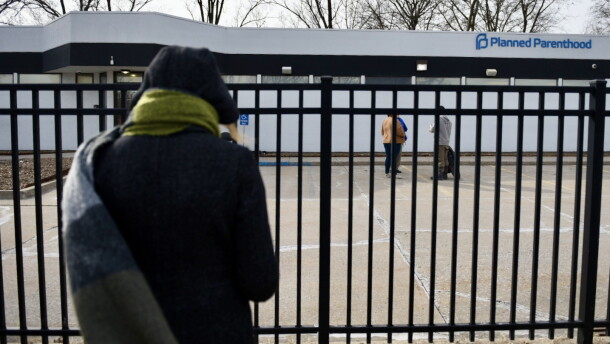 An activist with 40 Days for Life prays as she stands outside the Columbia Planned Parenthood clinic on Monday, March 3, 2025 shortly after the clinics restarted procedural abortions under the state's reproductive rights amendment (Anna Spoerre/Missouri Independent).