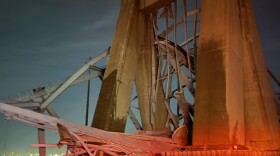 The wreckage of the Francis Scott Key Bridge lays in the Patapsco River early Tuesday morning.