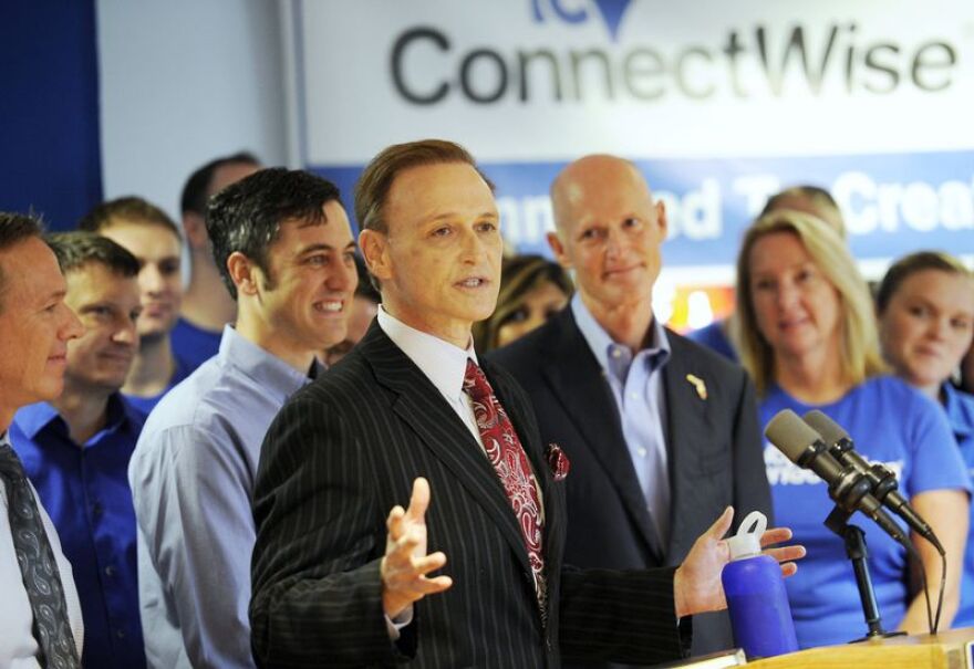  Arnie Bellini, left, Chief Executive Officer of ConnectWise speaks as Florida Governor Rick Scott, right, and others look on during a news conference at ConnectWise Tuesday, Sept. 8, 2015 in Tampa. 